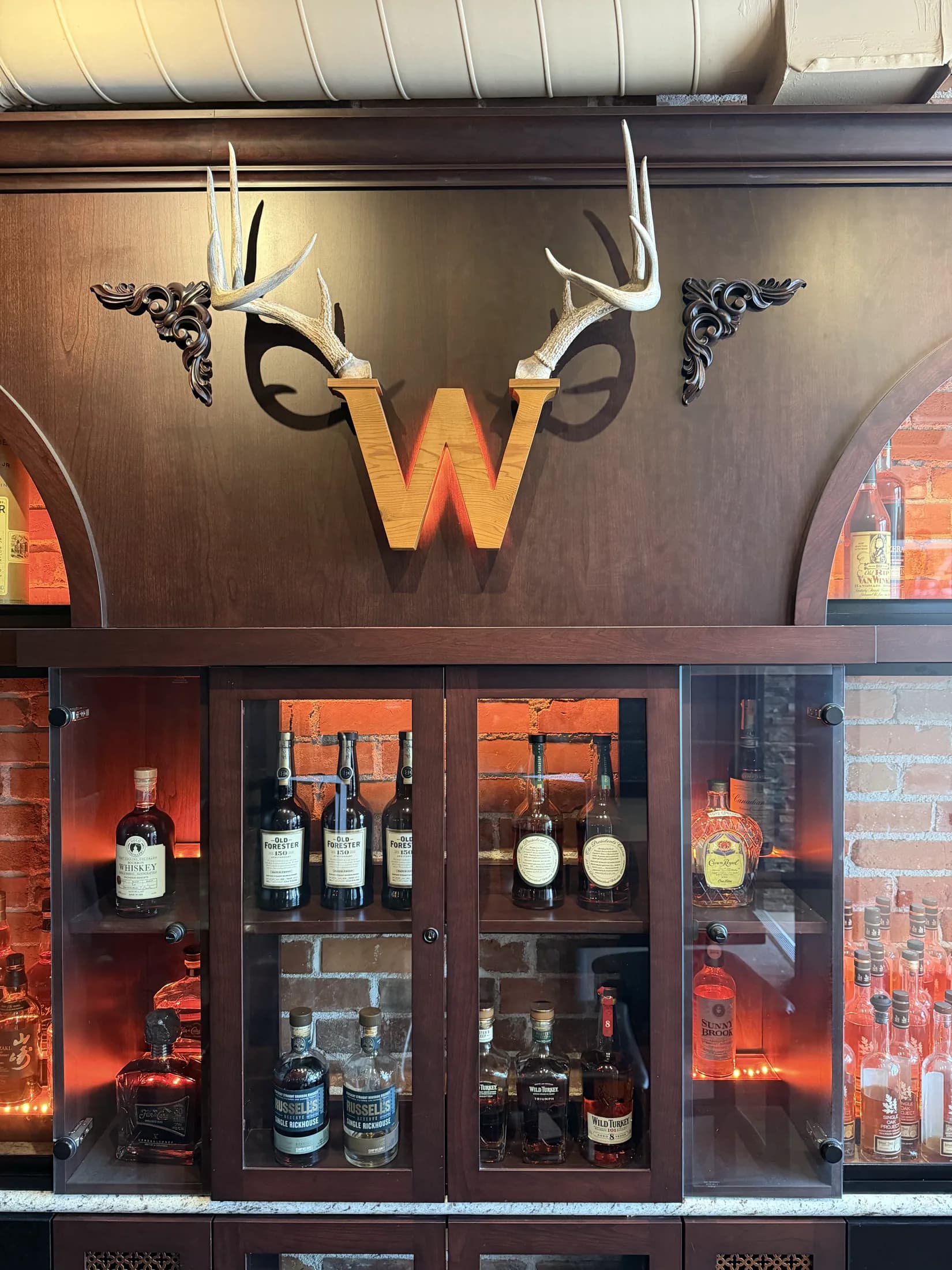 The official Whisk(e)y antler W above the back bar